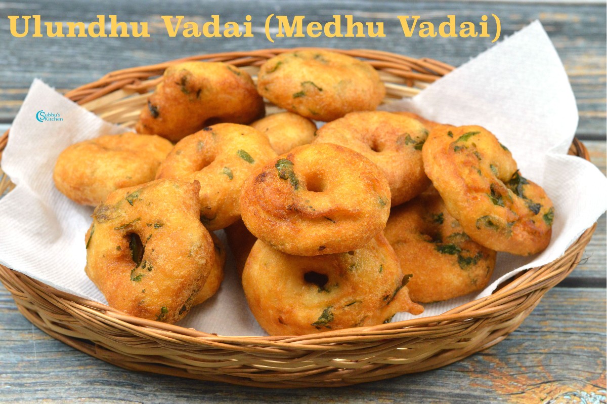 A close-up of crispy, golden-brown Medhu Vadai, a traditional South Indian savory snack, served with coconut chutney and sambar, showcasing its perfectly round shape and fluffy texture.