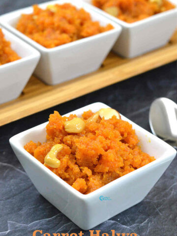 A bowl of rich and creamy Carrot Halwa (Gajar Ka Halwa) garnished with fried cashews, almonds, and pistachios.