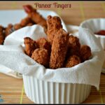 Golden and crispy Paneer Fingers, coated with spiced batter and deep-fried to perfection, served with a side of chutney for a delicious snack or appetizer.