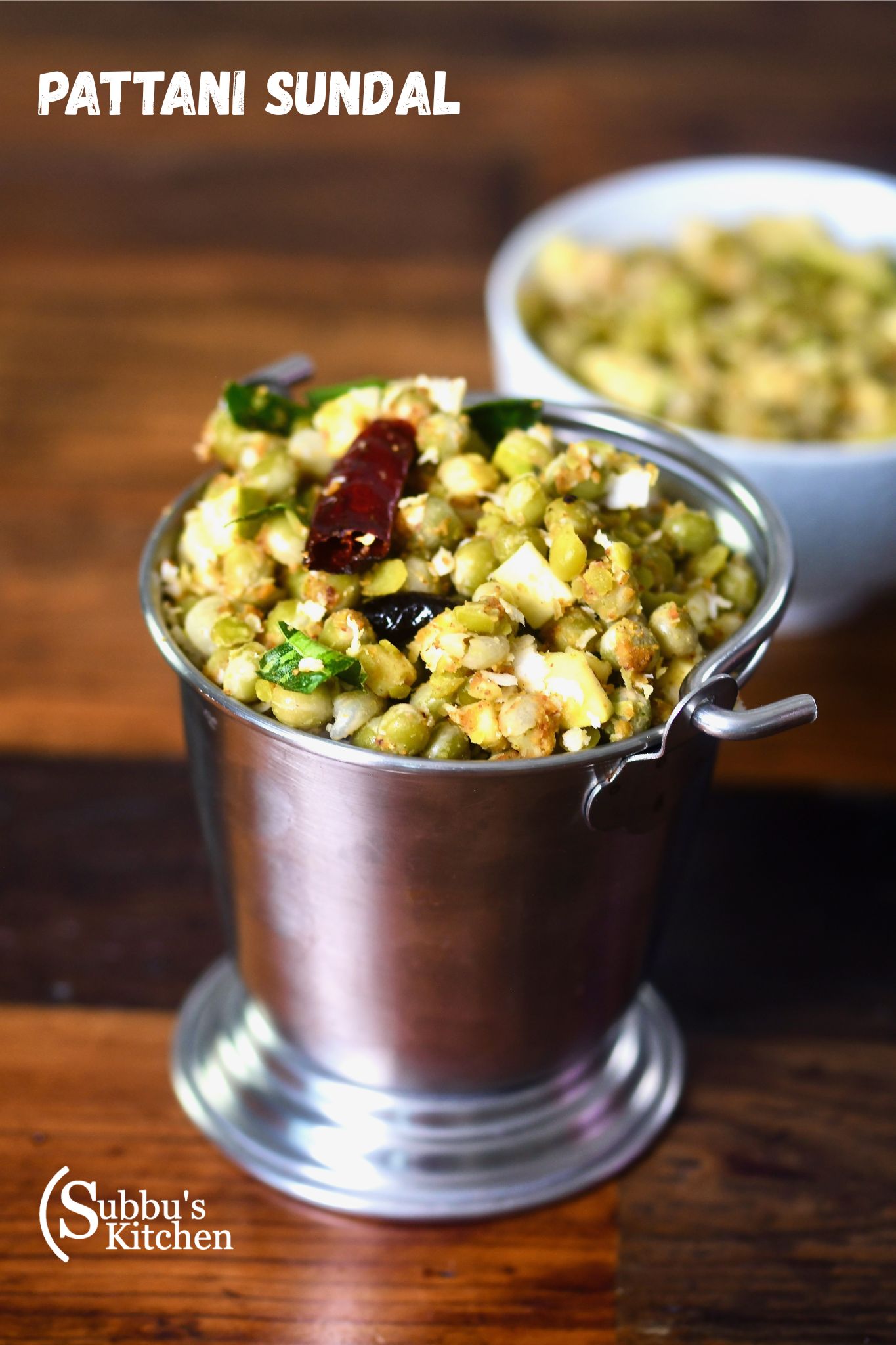 A bowl of Peas Mango Sundal (Pattani Sundal) garnished with grated coconut and raw mango, a traditional South Indian festival snack.